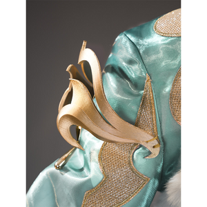 Zibai cosplay costume shoulder ornament with gold swirl design on teal fabric