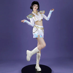 The cosplayer strikes a dynamic pose, highlighting Zoey’s costume with iridescent shoulder armor, gold - trimmed crop top, patterned sleeves, and a skirt adorned with chains, all paired with white lace - up boots against purple.