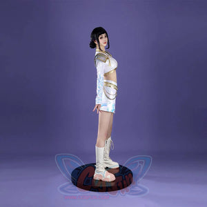 The side view showcases Zoey’s form - fitting costume: gold - trimmed crop top, patterned sleeves, a skirt with chain accents and blue designs, and white boots, all against a purple background.