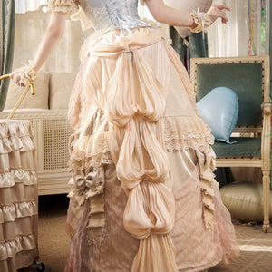 Back view of the skirt with layered bustle drape and trailing train