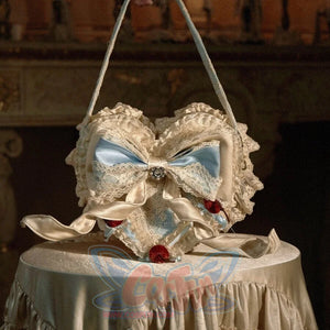 Blue heart cake handbag front view with lace ruffles, satin bow layers, and cherry accents