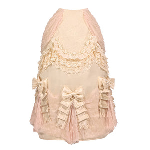 Flat lay of a cream bustle skirt with lace trim and bow accents