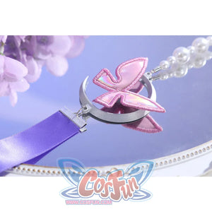 Butterfly charm close-up of Castorice cosplay costume with pink wing ornament, silver crescent, and pearl chain