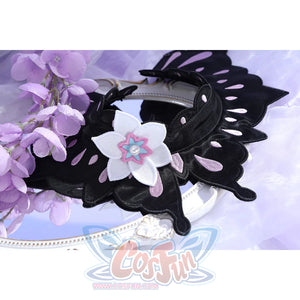 Flat lay of Castorice cosplay costume black collar with winged petal shape, white flower, and pink center