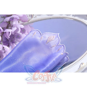 Sleeve close-up of Castorice cosplay costume with purple fabric, pale embroidered shapes, and scalloped edge
