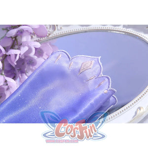 Sleeve close-up of Castorice cosplay costume with purple fabric, pale embroidered shapes, and scalloped edge
