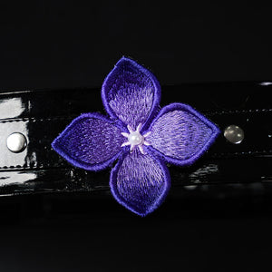 Honkai: Star Rail Castorice Gossamer Flutter cosplay costume presents a dark purple embroidered flower upon a glossy strap.