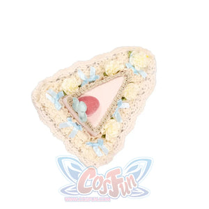 Flat lay of the Cherry Mousse Cake Headpiece item with cream lace, pale blue bows, and strawberry detail