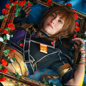Clair Obscur: Expedition 33 Sciel cosplay costume close-up centers the strapped bodice and gold-tone chest ornament.