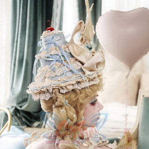 Side view of the Cream Pointed Hat item showing lace trim and ribbon streamers