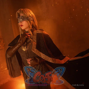 Dark Souls III Fire Keeper cosplay costume angled view frames a black cloak over brown gloves and ornate trim.