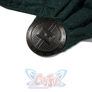 Doctor Doom cosplay cape ornament close-up with a round dark clasp on patterned green fabric.