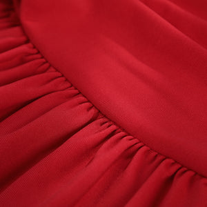 Elektra Natchios cosplay costume red stretch fabric gathers along a seam to create soft vertical folds in the material.