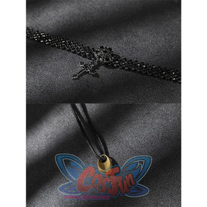 Close-up of a black beaded choker-style accessory and a black cord with a small gold-toned end piece.