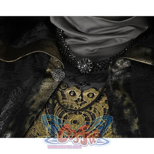 Close-up of the Fire Keeper cosplay collar and neckline with black beaded trim, clasp detail, and gold embroidery.