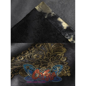 Close-up showing black textured fabric with mottled gold trim and an ornate gold embroidered lace applique.