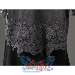 Close-up of the lower outer dress hem featuring layered black floral embroidery over the long black skirt.