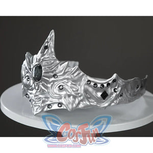 Angled view of the Fire Keeper silver mask accessory displayed alone, showing sculpted contours and dark gems.