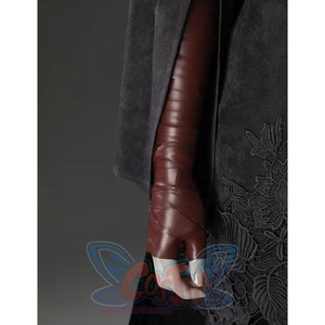Close-up of the Fire Keeper costume sleeve and brown glove, with black embroidered skirt panel visible at the side.