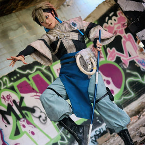 COSFUN Gachiakuta Zanka Nijiku cosplay costume sets a blue apron over loose pants beside a staff and boots