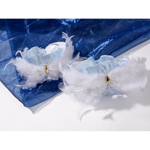 Genshin Impact Snezhnaya Odette cosplay feather cuffs flat lay pairs white plumes with small gold-tone accents.