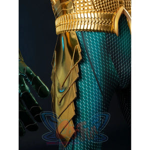 Gold-tone armored cosplay hip guard detail overlaps pointed panels against teal scale fabric.