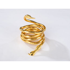 Product view of Charlie Morningstar snake arm cuff with gold coiled body, black eyes and open bracelet ends