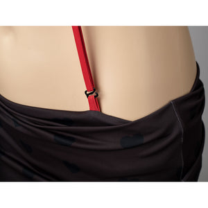 Hazbin Hotel Husk cosplay swimsuit detail anchors a red side strap beside the black skirt wrap.