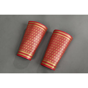 Pair of red shin guards for Homelander cosplay costume from The Boys with gold trim