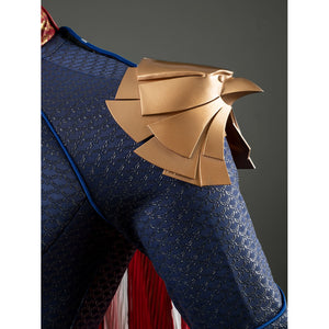 Homelander cosplay costume shoulder armor side view curves gold-tone plates across the upper sleeve.