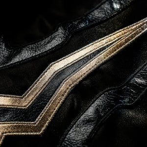 Honkai Star Rail Khaslana cosplay coat detail follows sharp gold embroidery across black fabric