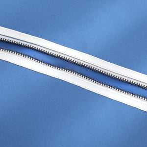Human Torch Johnny Storm cosplay costume fabric layers gather at a secure silver-tone zipper track on blue textile.
