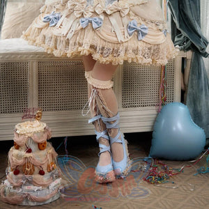 Cropped front styling view of the Lace Bow Skirt item with cream lace and blue bow accents