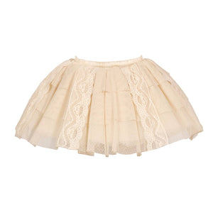 Flat lay of a beige lace skort with dotted mesh layers and vertical lace panels
