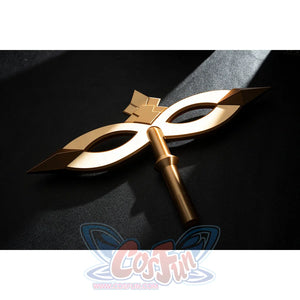 Genshin Impact Marionette Sandrone cosplay costume lays the gold-tone mask prop across black fabric.