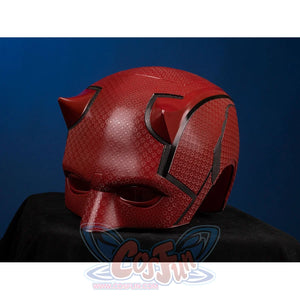 Matt Murdock cosplay helmet curves into horned headgear with detailed red textured surfaces and dark trimmed accents.