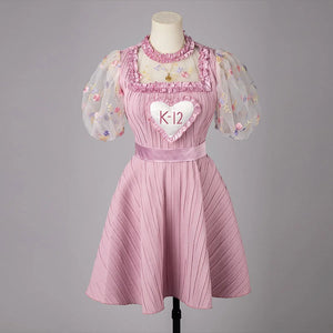 COSFUN Melanie Martinez K-12 Cry Baby cosplay dress layers a pink pleated skirt under sheer puff sleeves.
