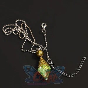 Flat lay of Re:Zero Emilia cosplay costume necklace with green gem pendant, gold setting, and silver chain