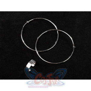 Two large silver hoop earrings and a matching silver ring accessory are displayed on a black background