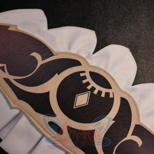 Close-up of Sandrone cosplay costume skirt pattern with black printed motif, beige trim, and white scalloped edge
