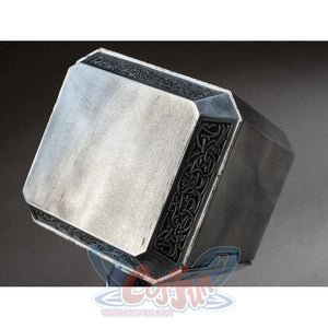 Thor cosplay hammer head gathers brushed metal surfaces that frame dark ornate knotwork patterns along the beveled edges.