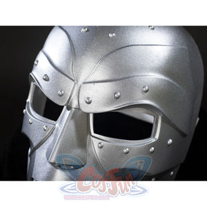 Victor Von Doom cosplay mask close-up frames angular eye openings beneath raised riveted brow plates.