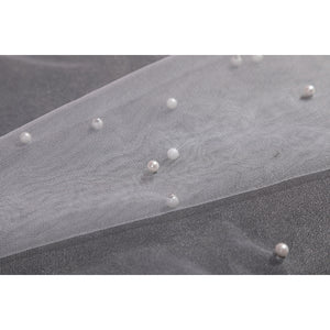 Wuthering Waves Aemeath cosplay beaded mesh detail scatters pearl-like beads across sheer white fabric.