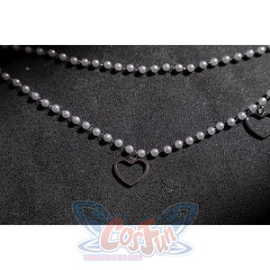 Wuthering Waves Aemeath cosplay waist chain detail drapes pearl-like beads around a small black heart charm.