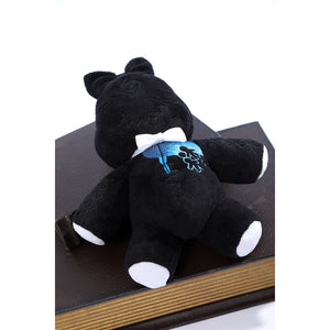 Wuthering Waves Denia cosplay black bear plush front detail presents blue chest embroidery and white paw accents.
