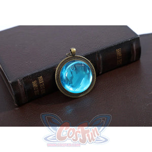 Wuthering Waves Denia cosplay gemstone pendant detail sets a bright blue oval inside an antique gold-tone frame.