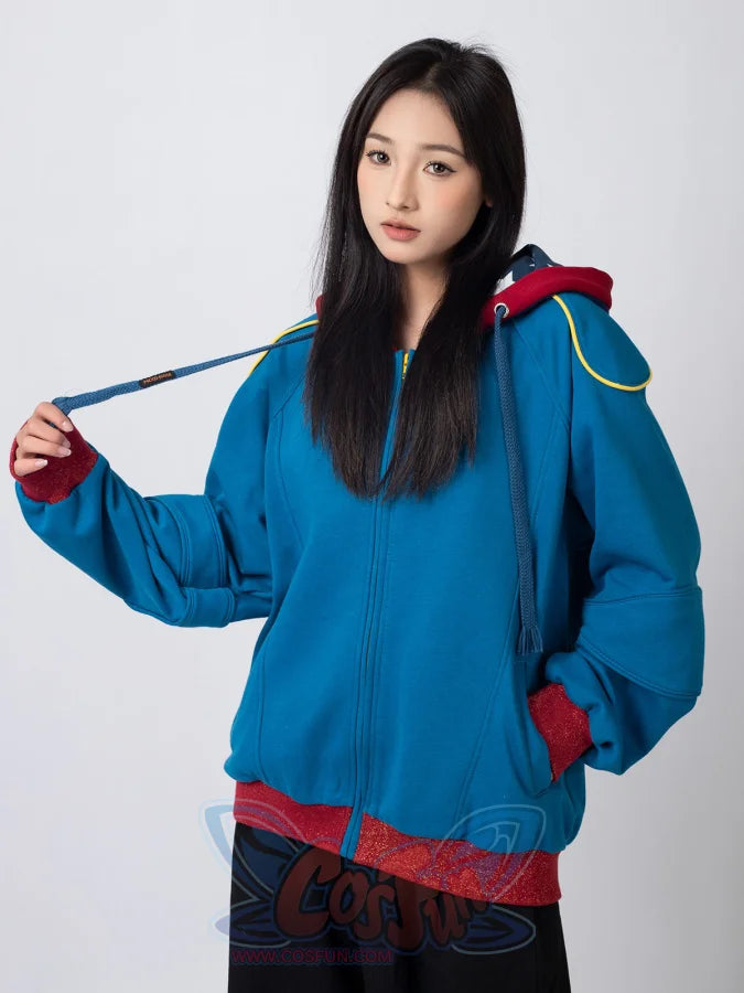Woman showcasing blue Homelander cosplay jacket with red cuffs and hood drawstring