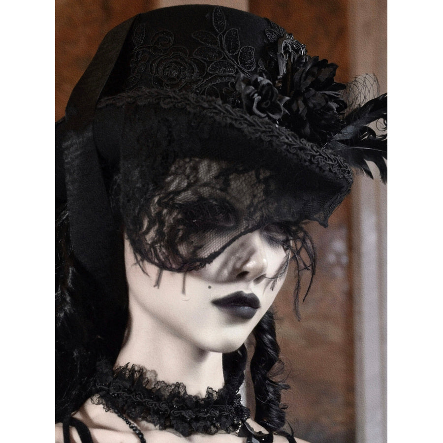 Side profile view of the black Gothic Victorian flat-top hat with embroidered rose pattern and black feather embellishments