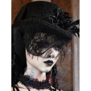 Side profile view of the black Gothic Victorian flat-top hat with embroidered rose pattern and black feather embellishments