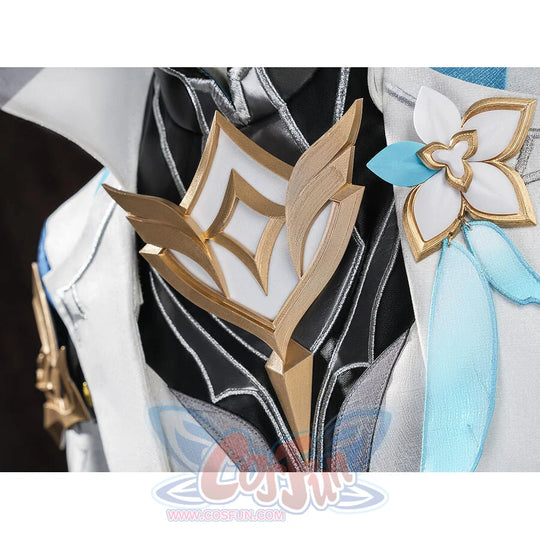 Close-up of Aether cosplay costume accessories: gold diamond chest emblem and white flower brooch with blue ribbon